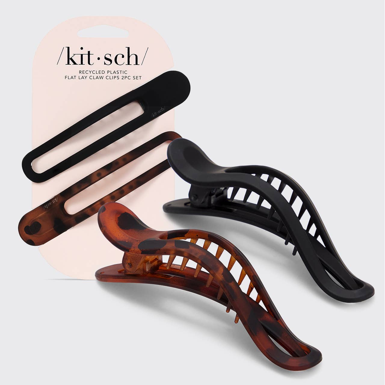 Two flat lay claw clips, one in black and one in a tortoise pattern, displayed on a card with 'kitsch' branding.